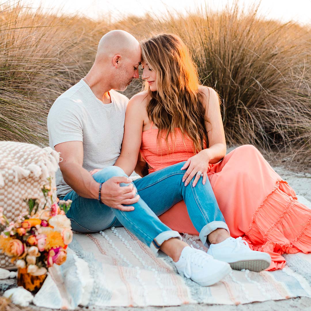 Portrait of a couple on the beach by Kristina Wikle